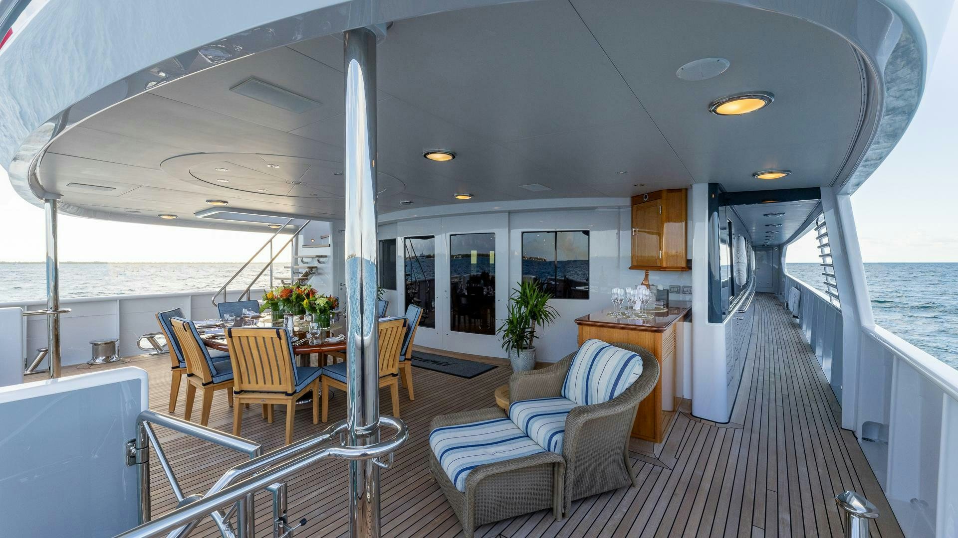 a large room with a table and chairs and a pool aboard AMANTI Yacht for Sale