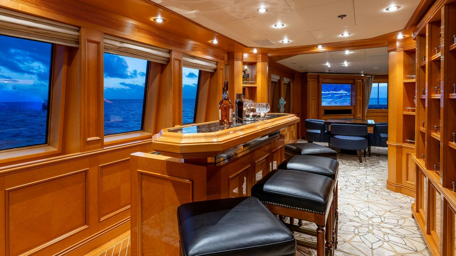 a room with a piano and chairs aboard AMANTI Yacht for Sale