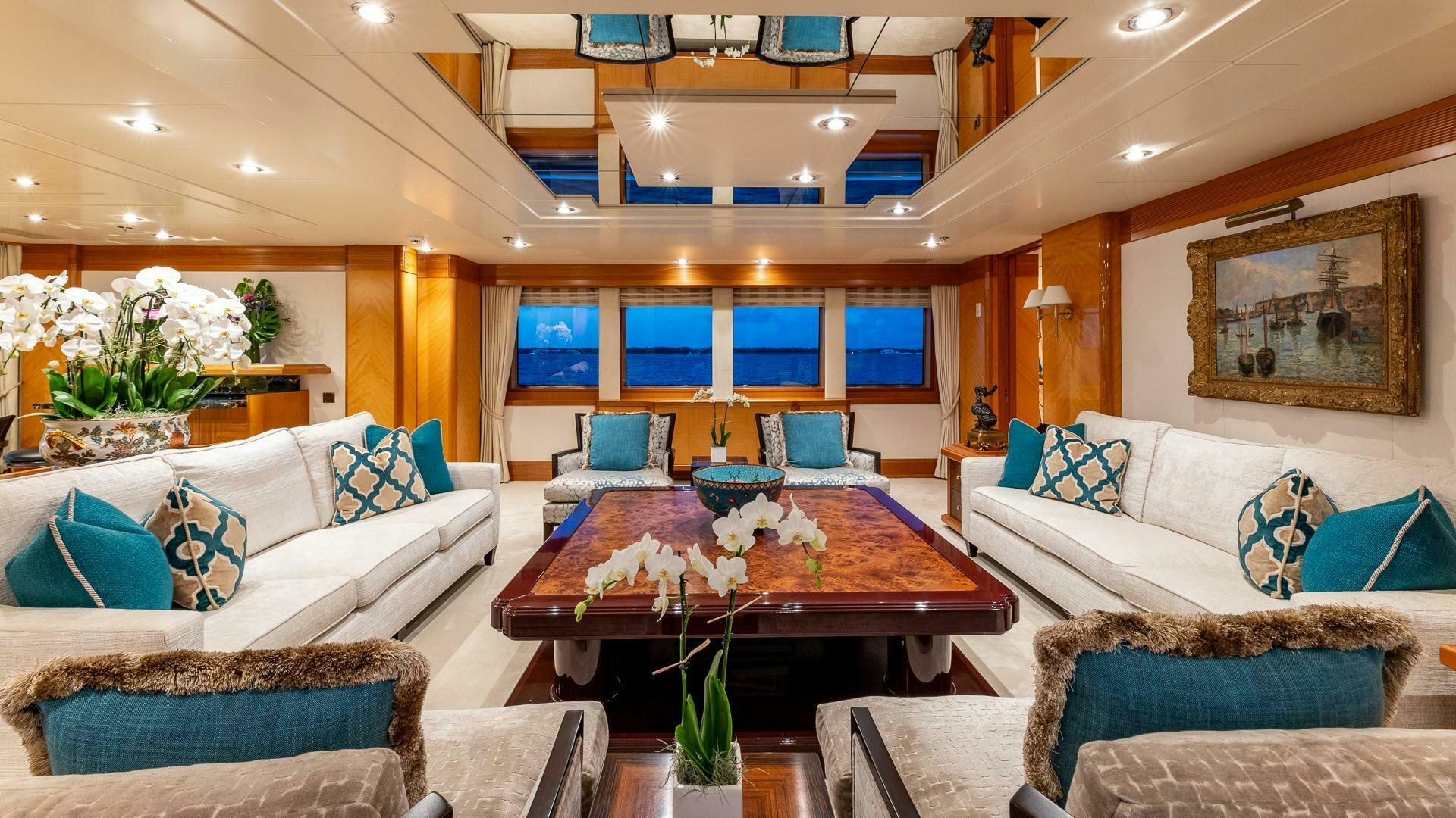 a living room with a table and couches aboard AMANTI Yacht for Sale