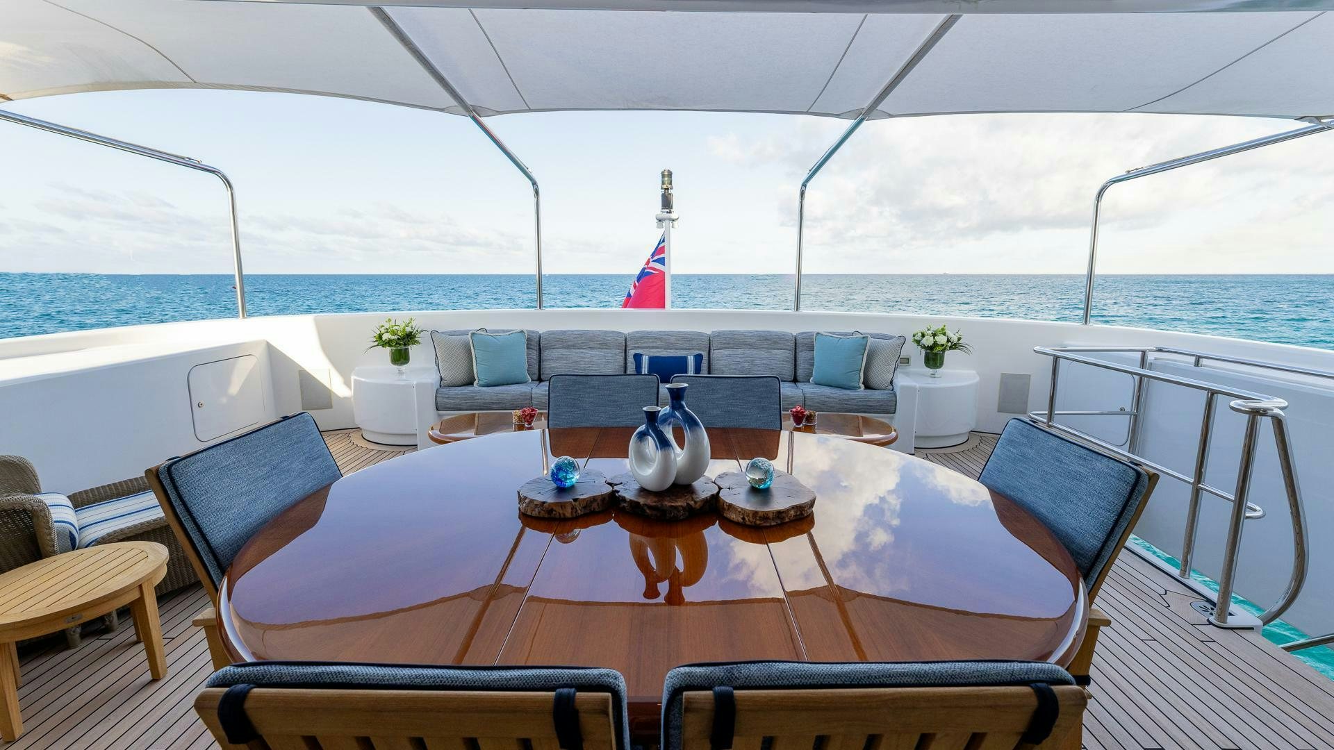 a table with chairs on it aboard AMANTI Yacht for Sale