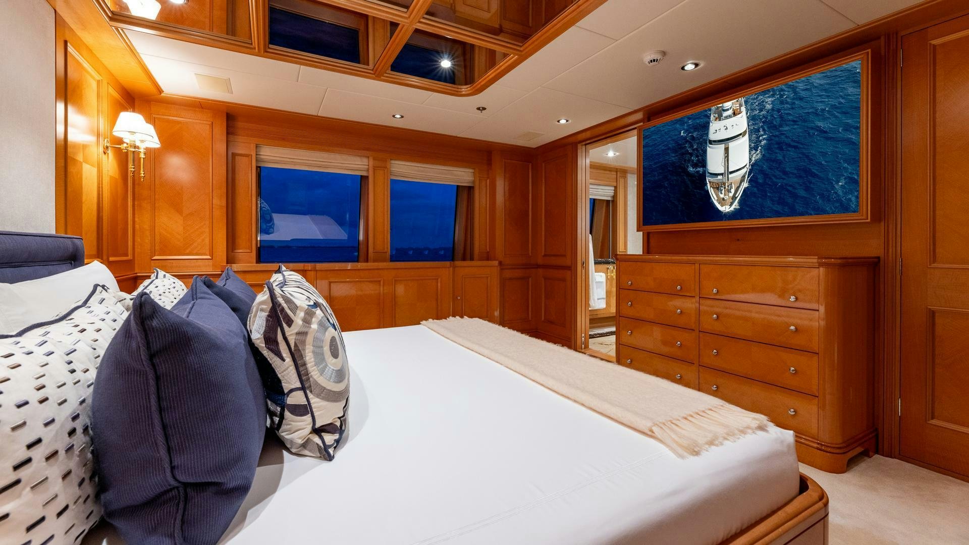a room with a bed and a dresser aboard AMANTI Yacht for Sale