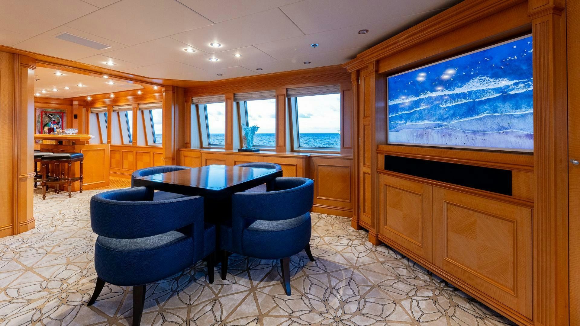 a room with a table and chairs aboard AMANTI Yacht for Sale