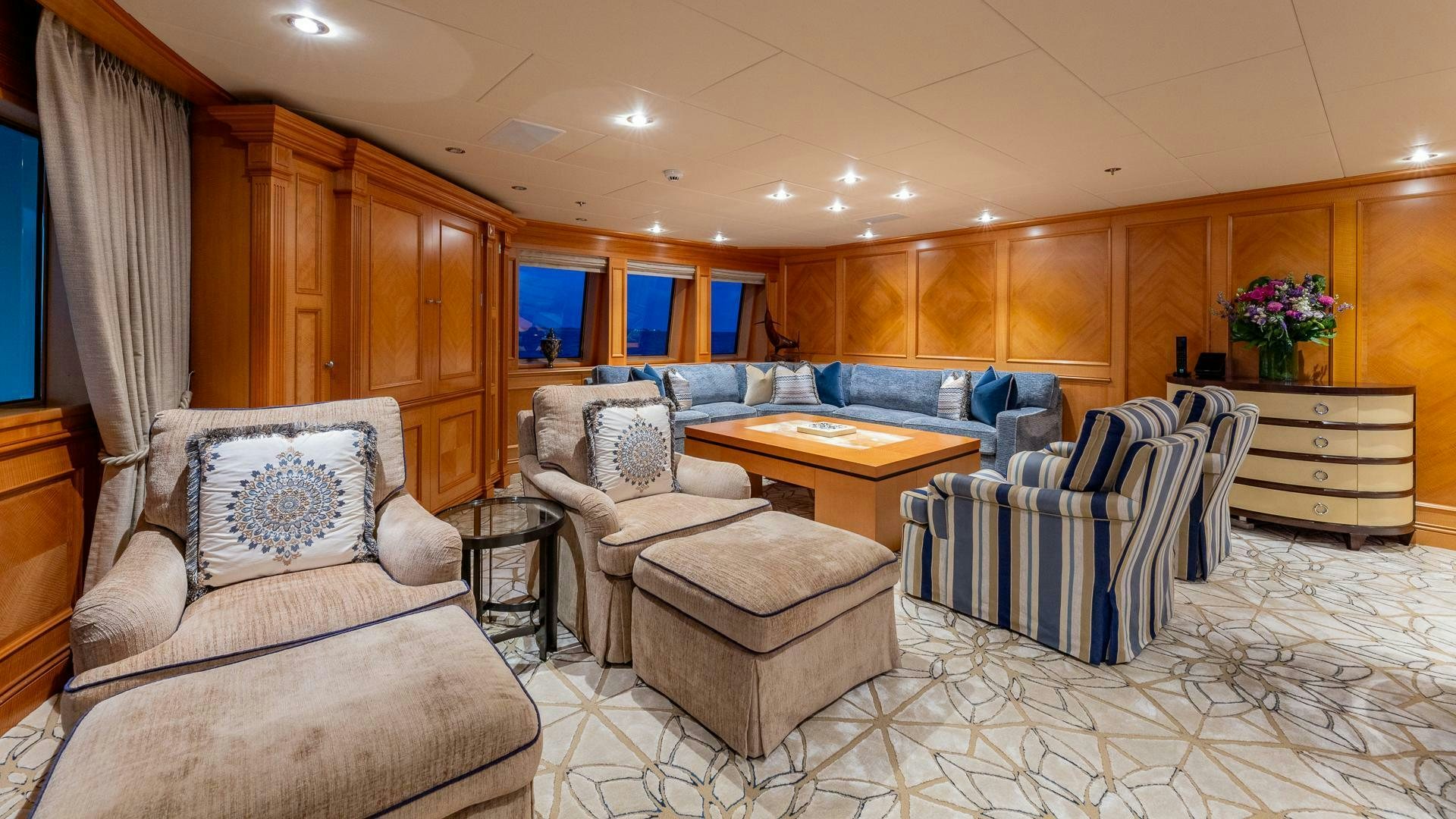 a living room with a couch and a table aboard AMANTI Yacht for Sale