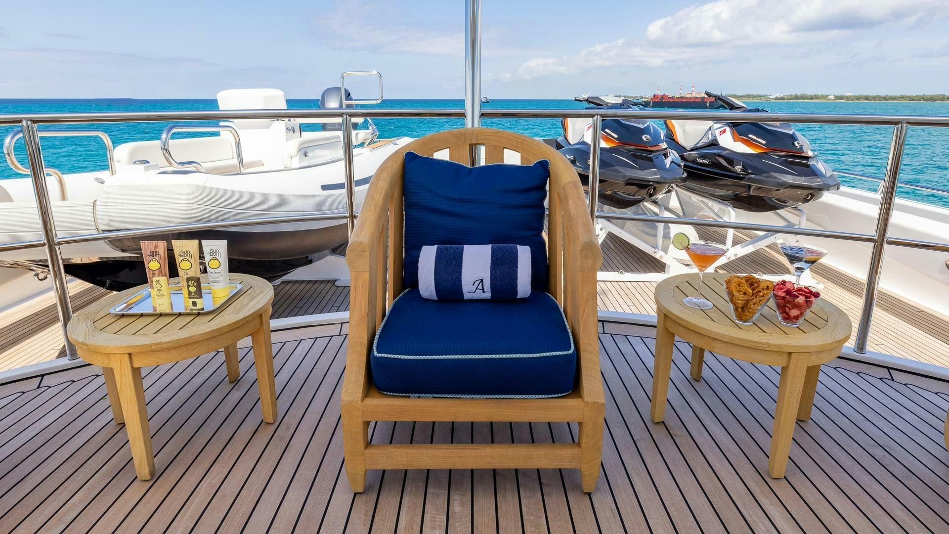 a chair on a deck overlooking a body of water aboard AMANTI Yacht for Sale