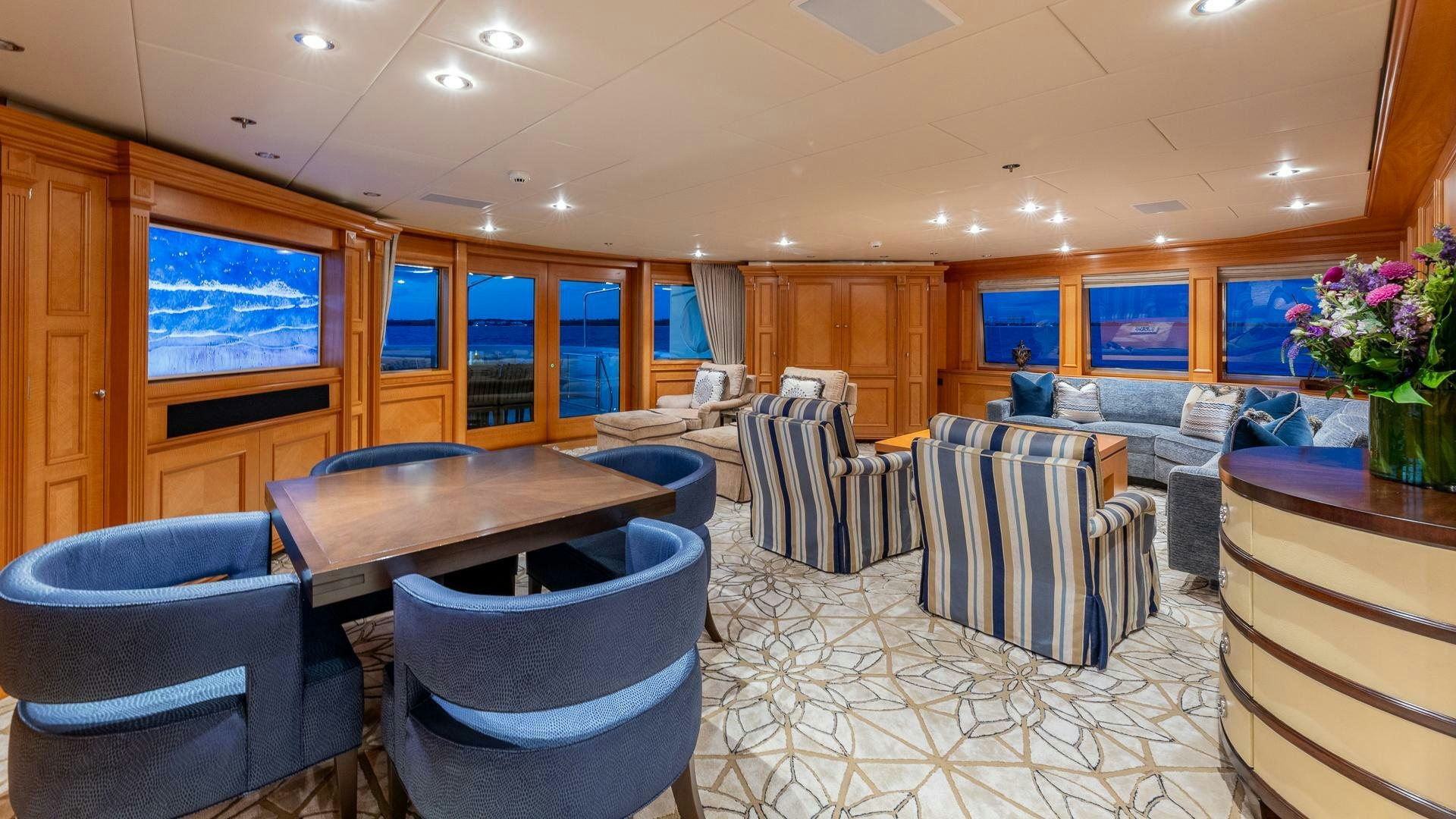 a large room with chairs and tables aboard AMANTI Yacht for Sale