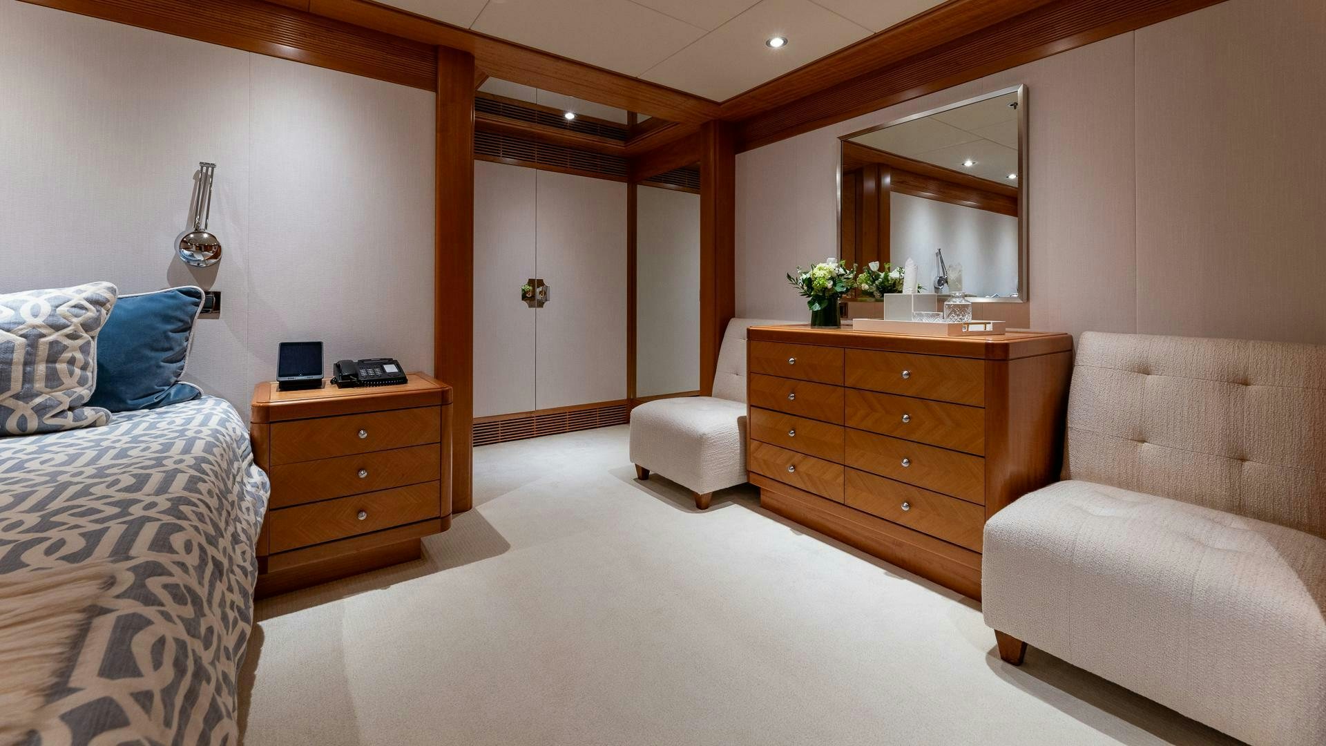 a bedroom with a bed and a dresser aboard AMANTI Yacht for Sale