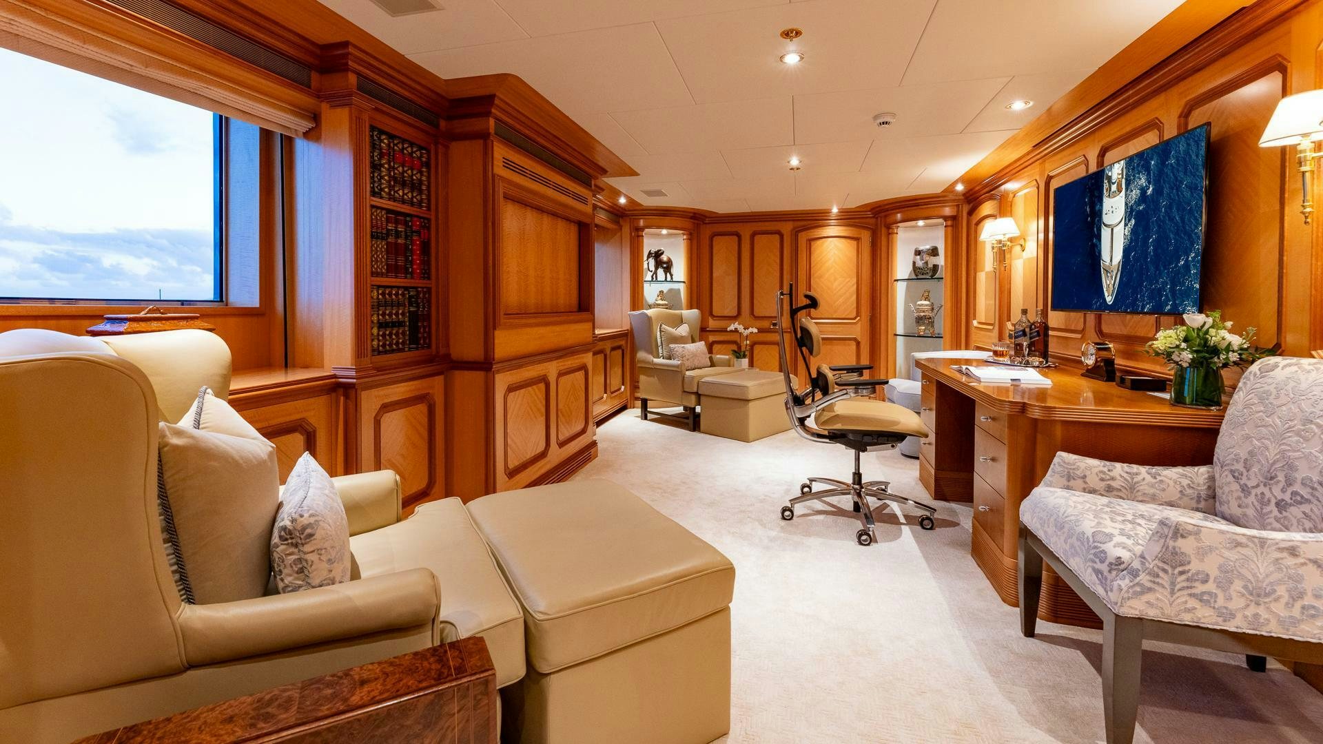 a living room with a piano and a piano aboard AMANTI Yacht for Sale