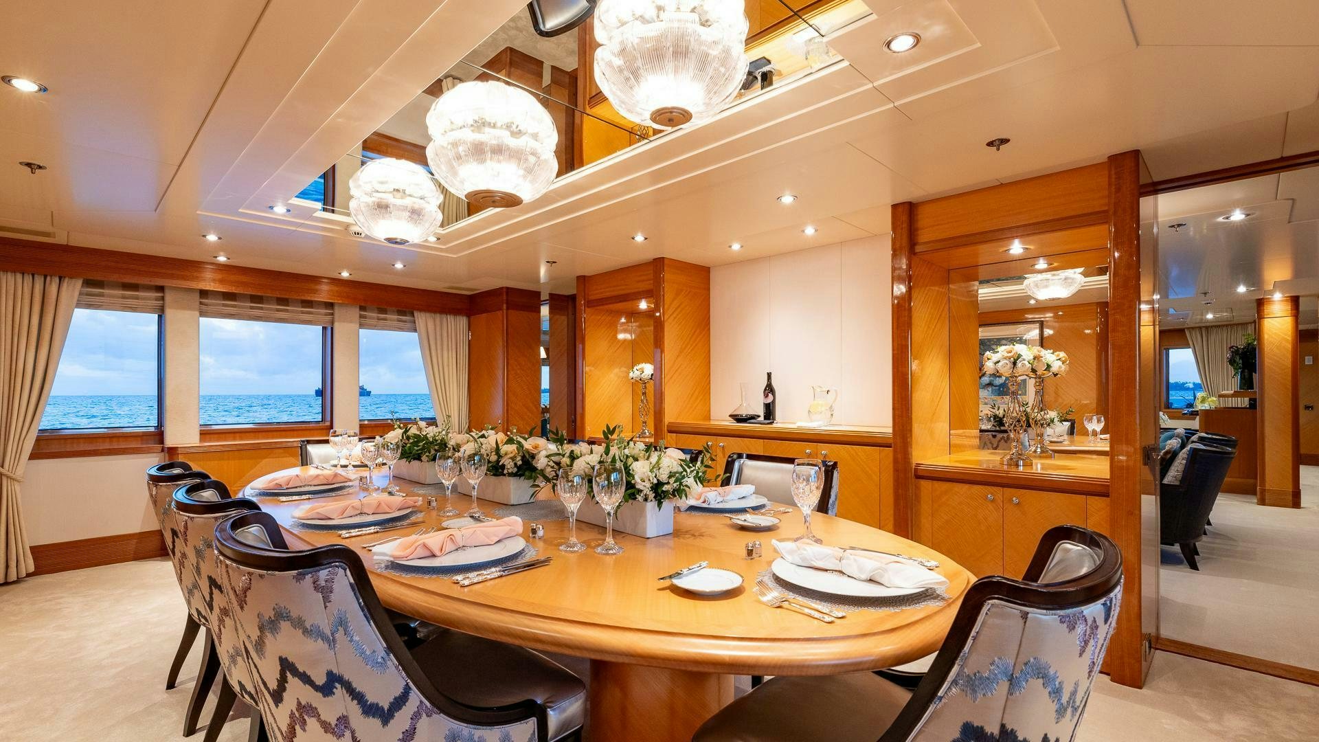 a dining room with a table set aboard AMANTI Yacht for Sale