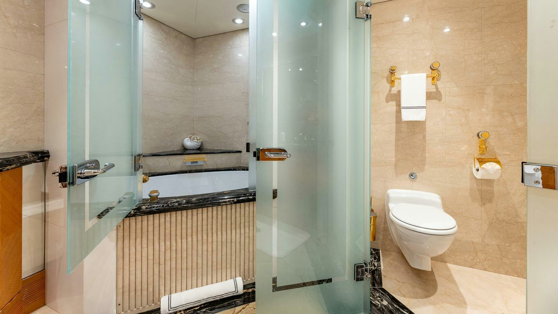 a bathroom with a glass shower door aboard AMANTI Yacht for Sale