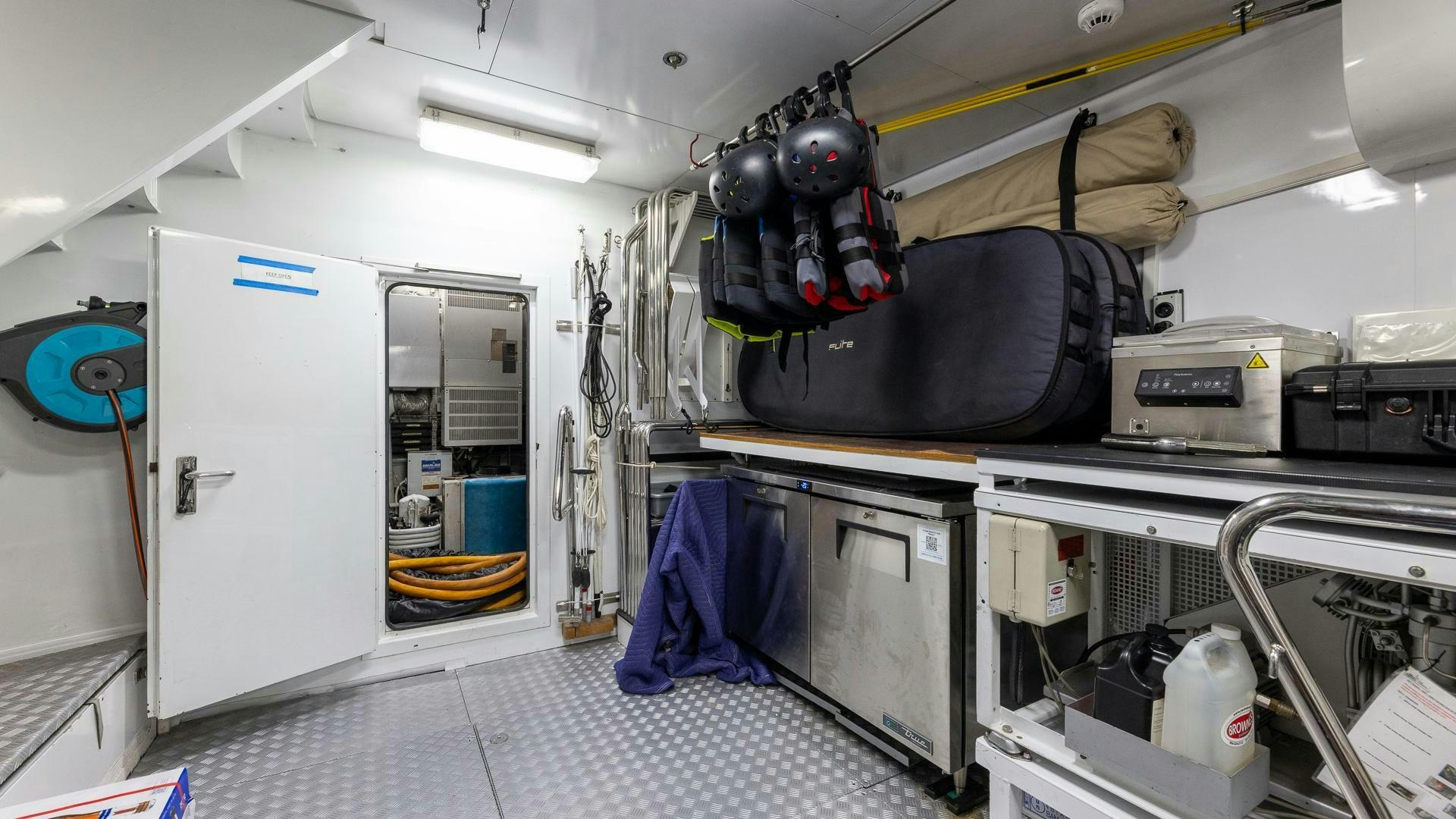 a room with a machine and equipment aboard AMANTI Yacht for Sale