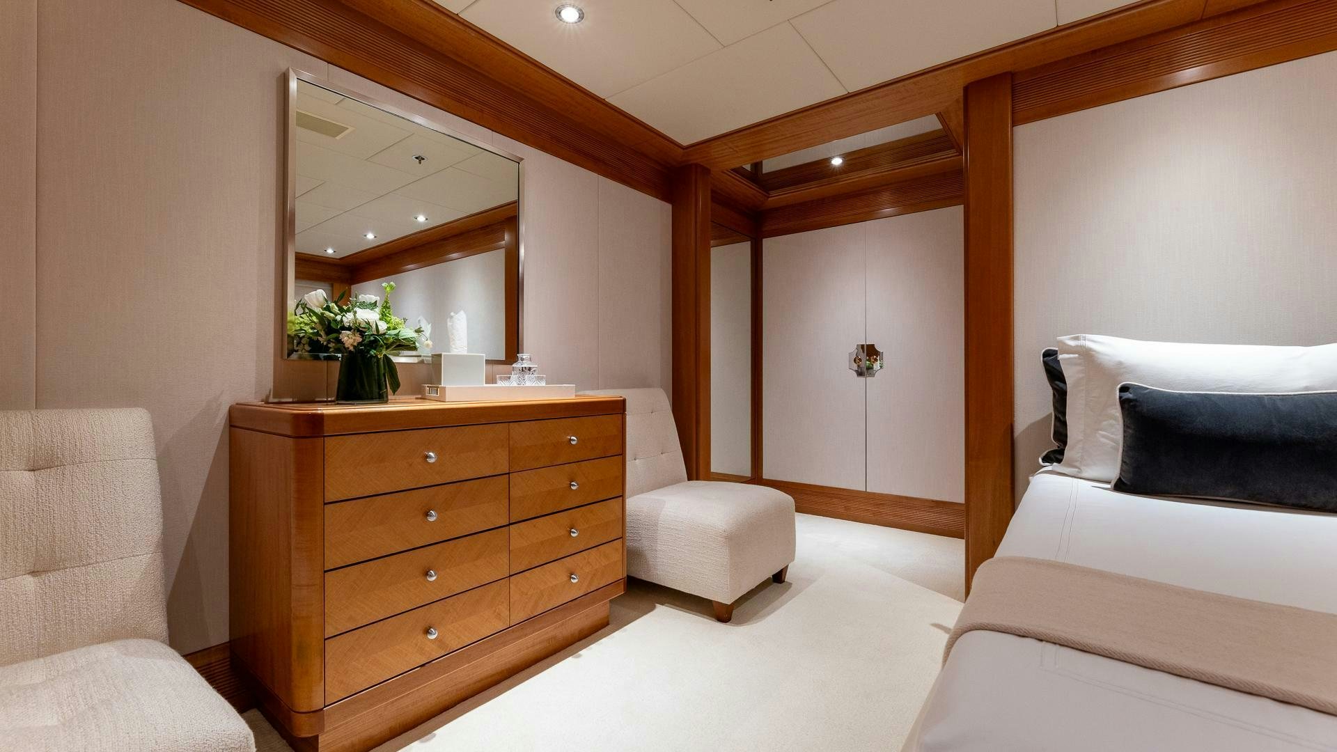 a room with a bed and a mirror aboard AMANTI Yacht for Sale