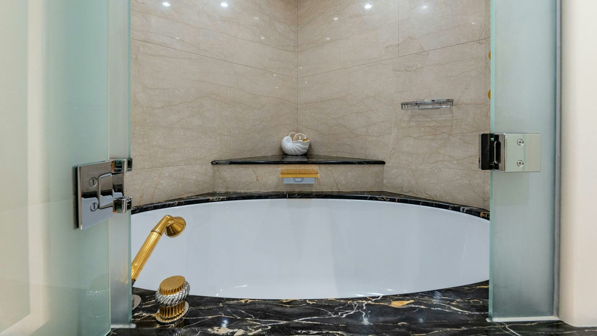 a bathroom with a tub and a sink aboard AMANTI Yacht for Sale