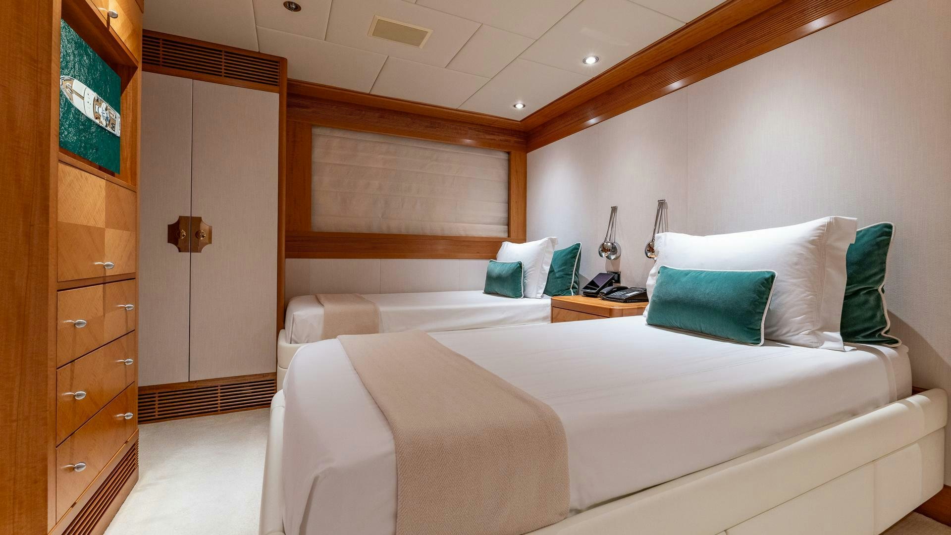 a room with two beds aboard AMANTI Yacht for Sale