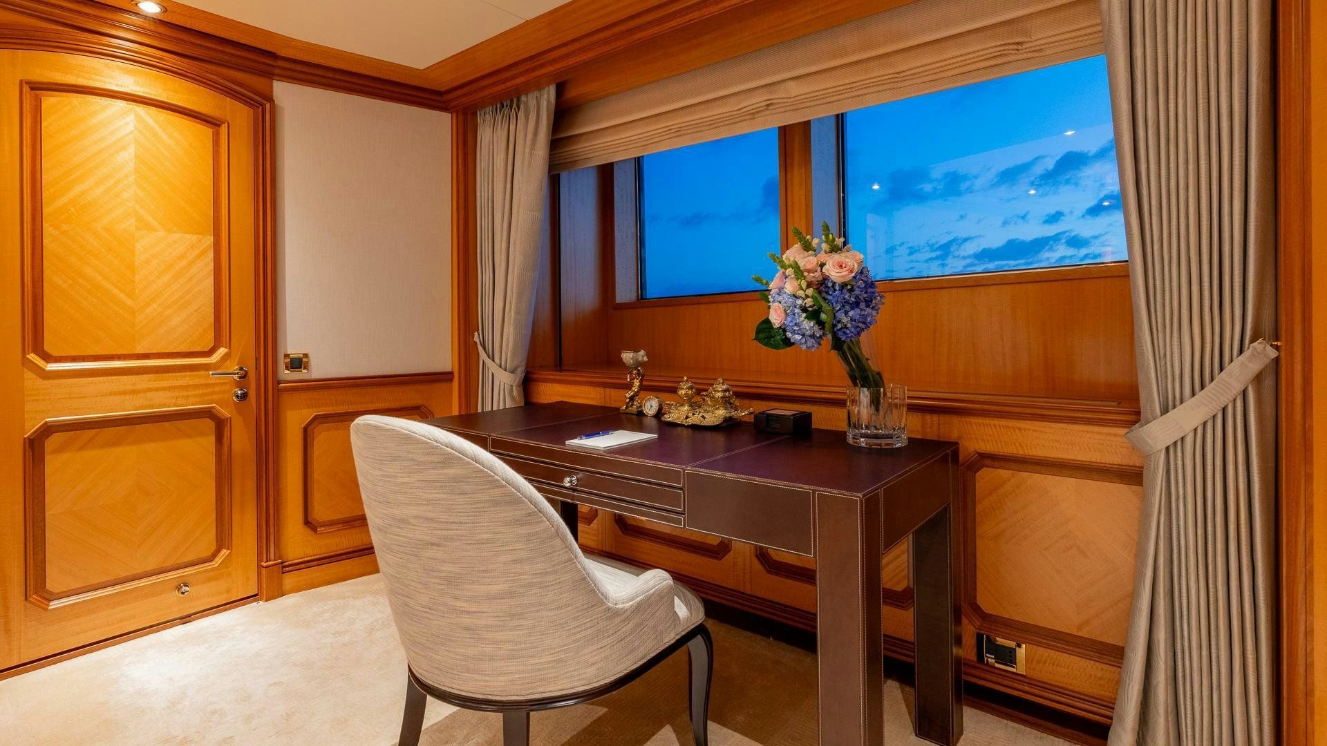 a room with a table and chairs aboard AMANTI Yacht for Sale