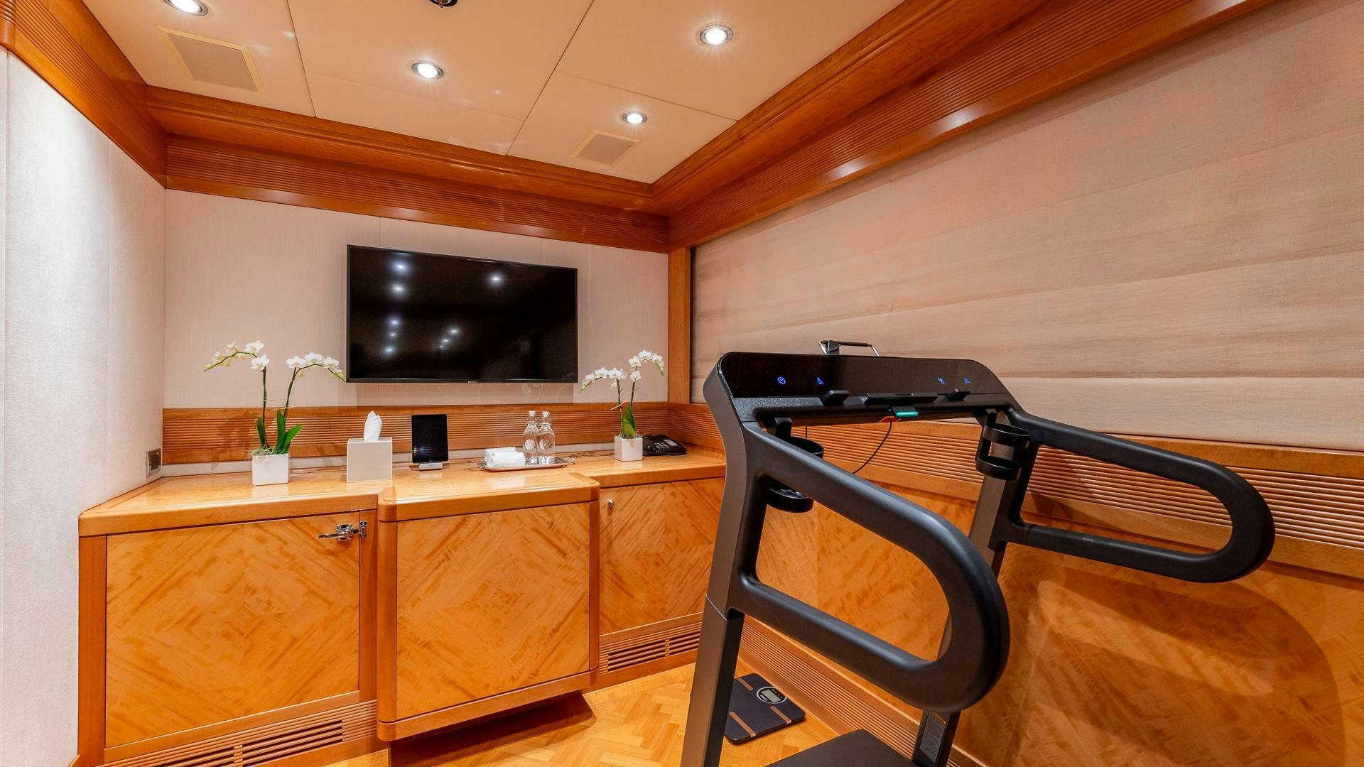 a room with a desk and tv aboard AMANTI Yacht for Sale
