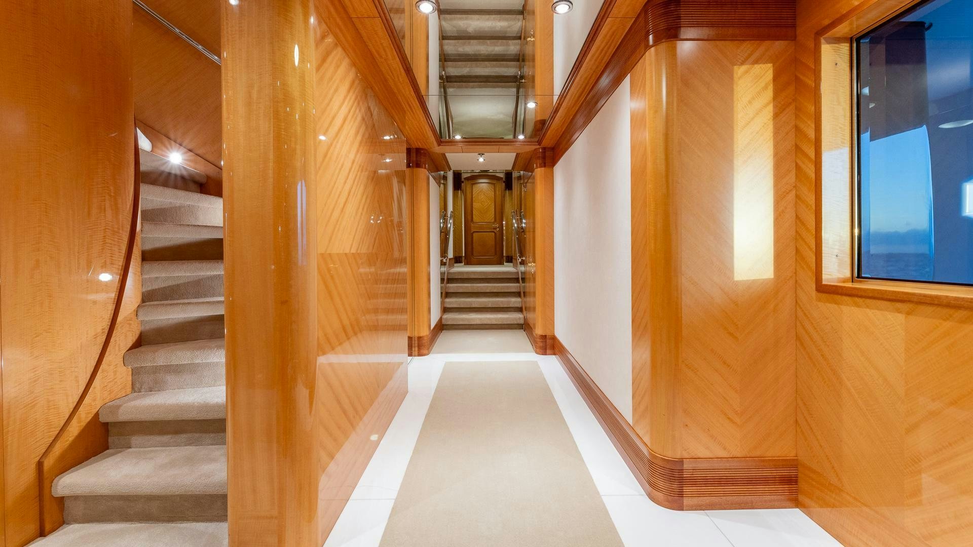 a long hallway with a set of windows aboard AMANTI Yacht for Sale