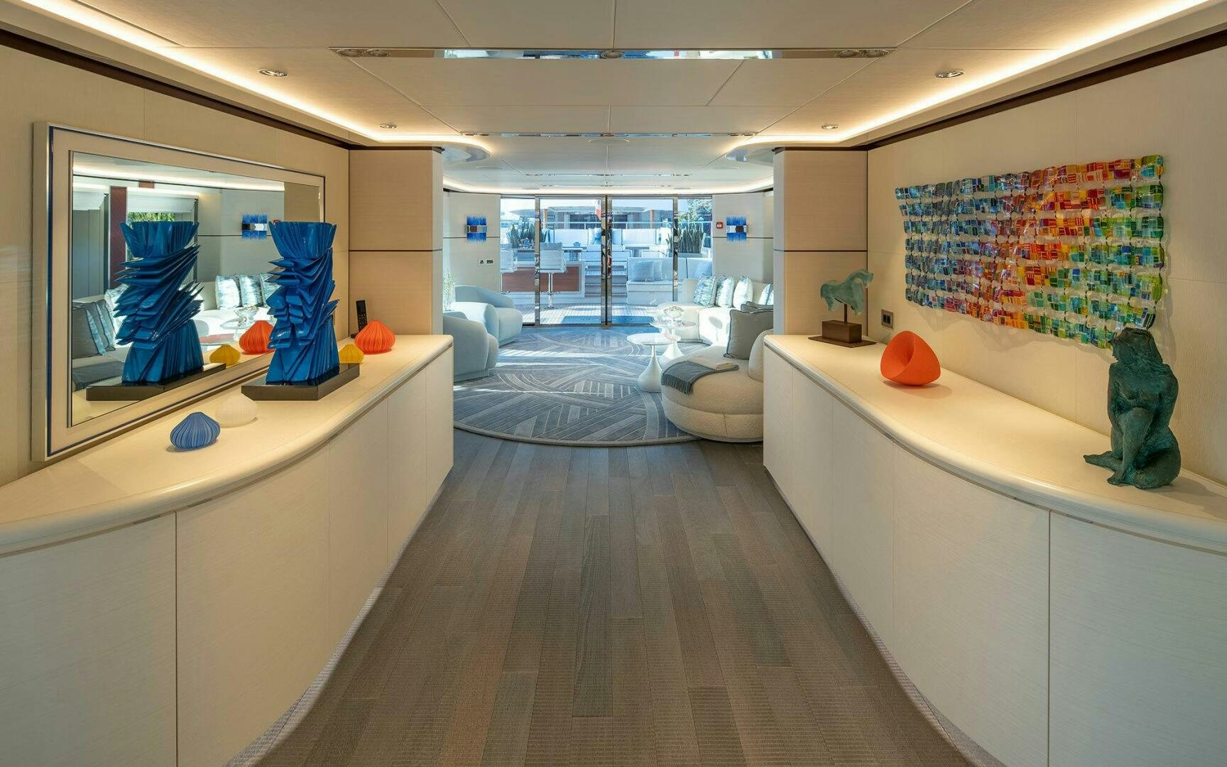 a room with a large mirror and a wood floor aboard BOOK ENDS Yacht for Sale