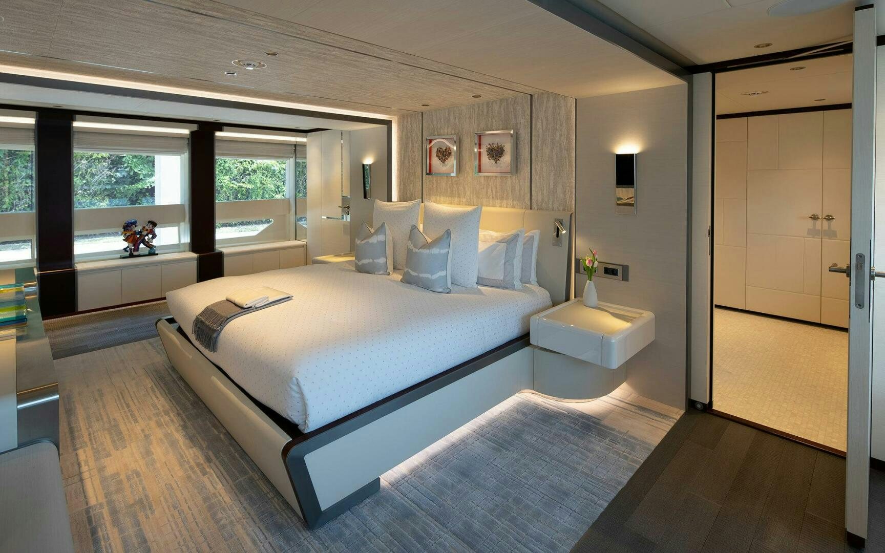 a large bedroom with a large bed aboard BOOK ENDS Yacht for Sale