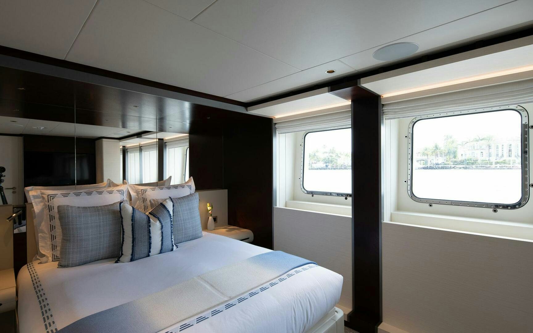 a bed with a blue pillow aboard BOOK ENDS Yacht for Sale