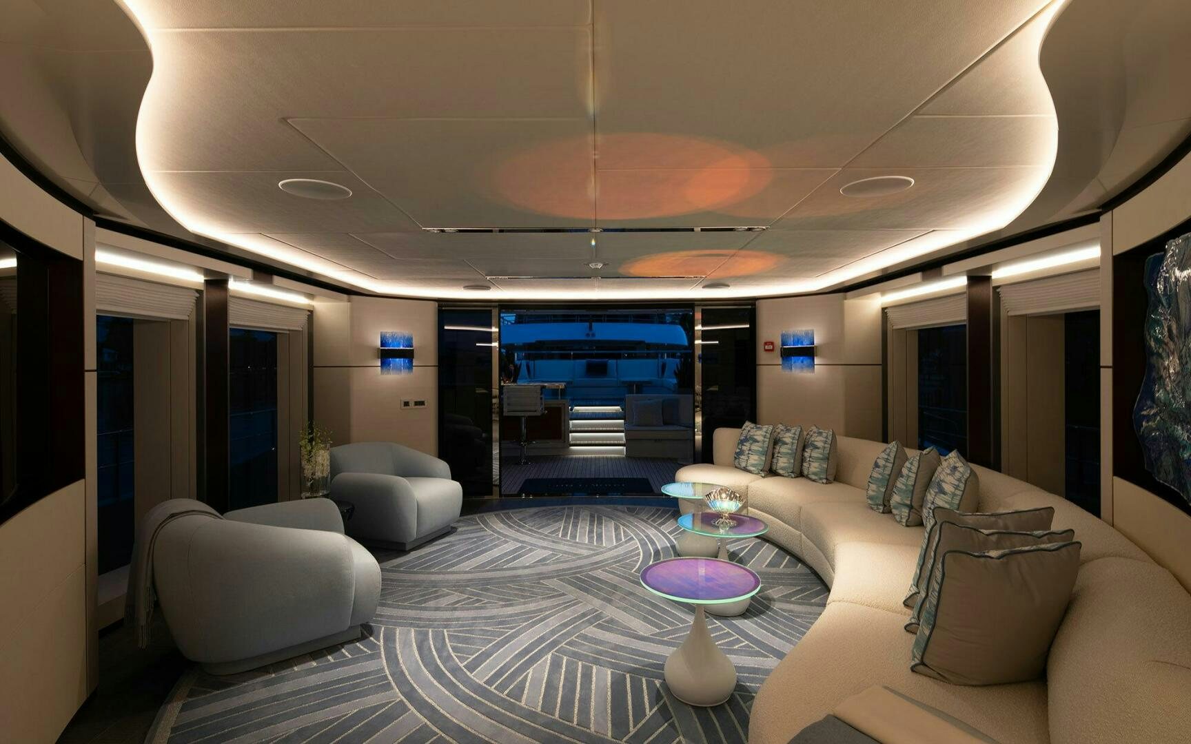 a large living room with a large swimming pool aboard BOOK ENDS Yacht for Sale