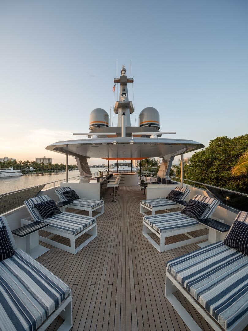 a deck with chairs and a large building with a dome on top aboard BOOK ENDS Yacht for Sale