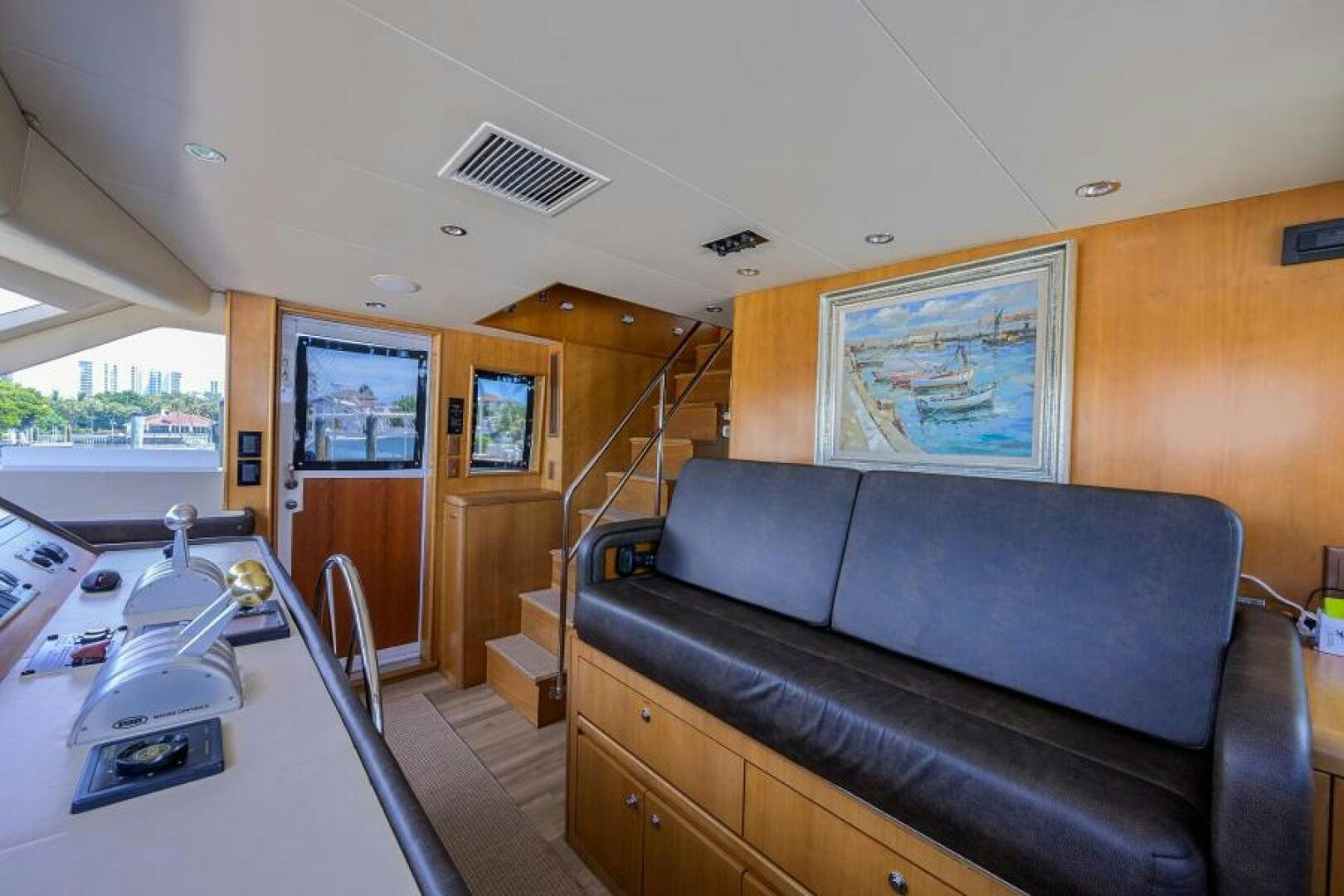 a living room with a couch and a tv aboard BELLAGIO Yacht for Sale