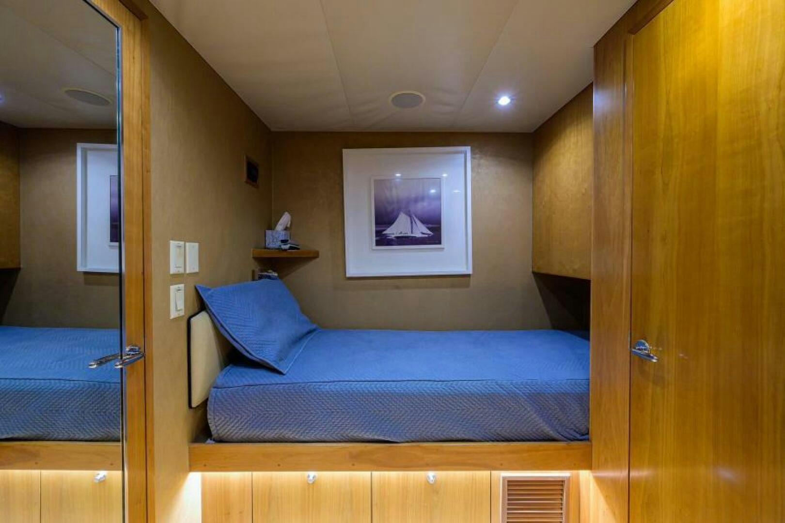 a bedroom with a bed and a mirror aboard BELLAGIO Yacht for Sale