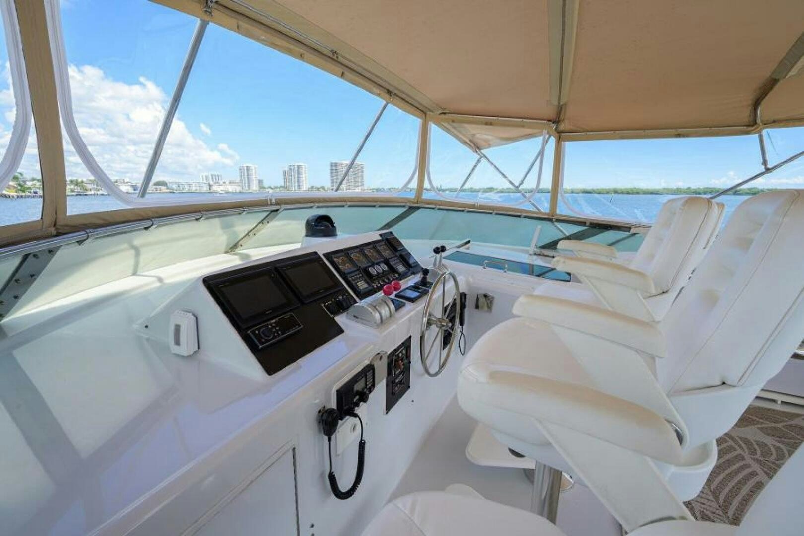 a boat with a white cover and a white bed and a white chair aboard BELLAGIO Yacht for Sale