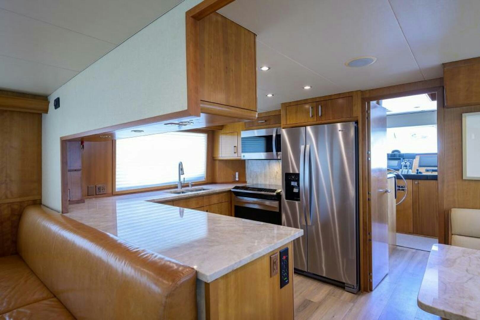 a kitchen with a stainless steel refrigerator aboard BELLAGIO Yacht for Sale