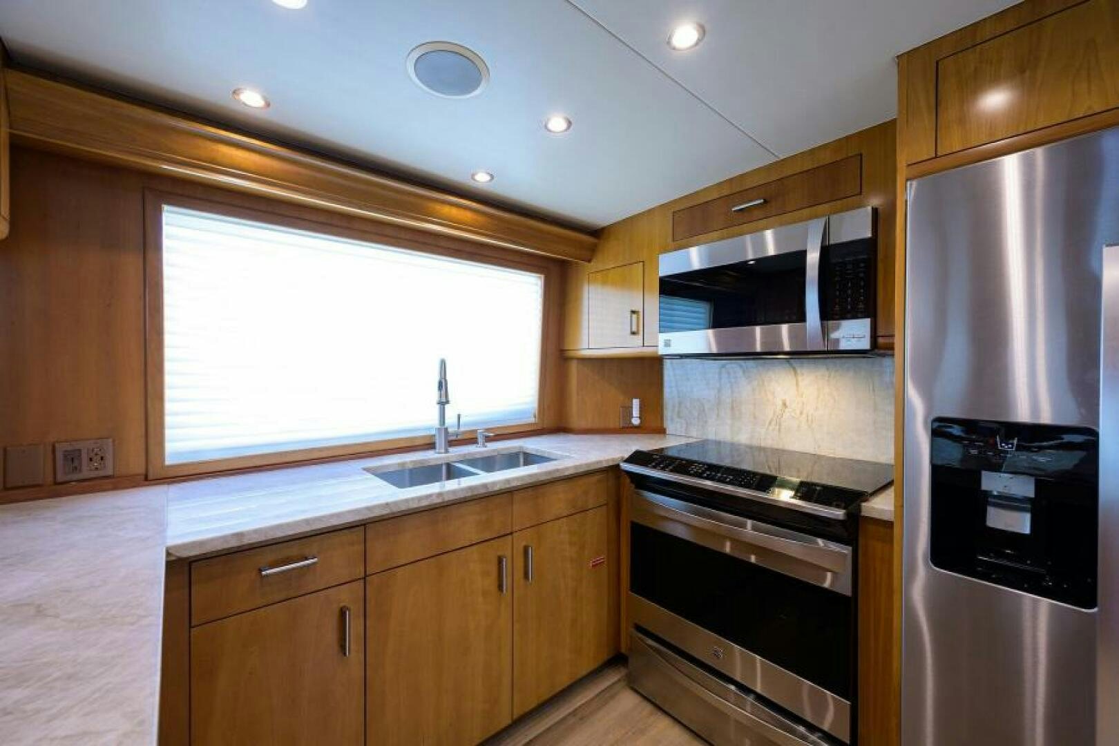 a kitchen with a stove and refrigerator aboard BELLAGIO Yacht for Sale