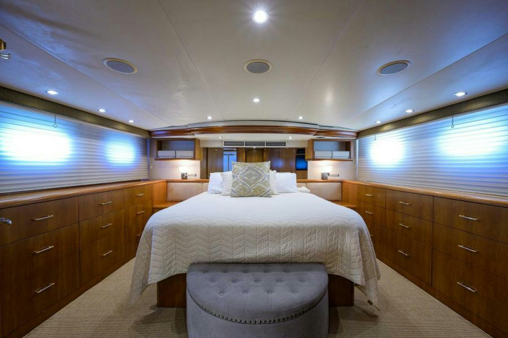 a bedroom with a bed and a table aboard BELLAGIO Yacht for Sale