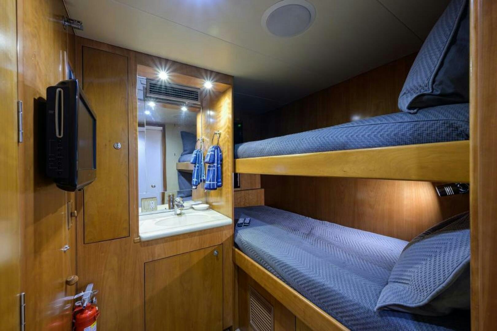 a room with a bed and a mirror aboard BELLAGIO Yacht for Sale
