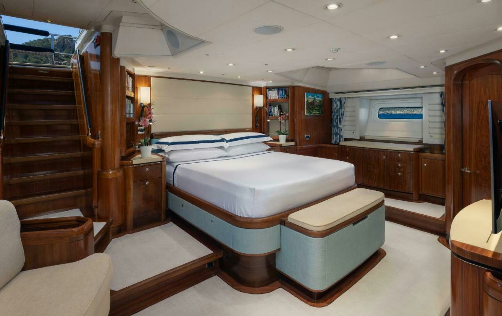 a room with a bed and a chair aboard ANTARES Yacht for Sale