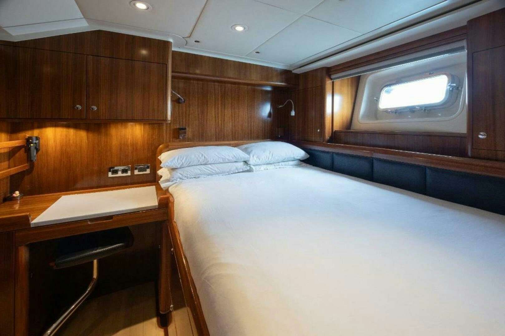 a room with a bed and a desk aboard ANTARES Yacht for Sale