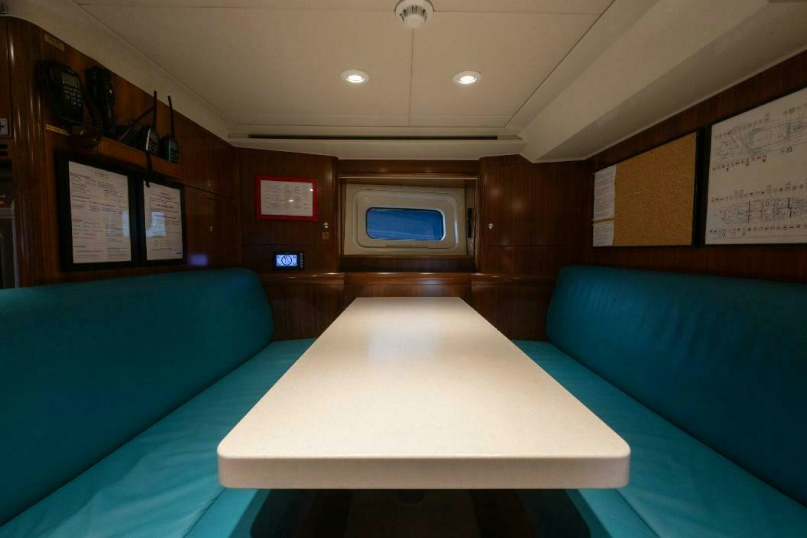 a room with a table and couch aboard ANTARES Yacht for Sale
