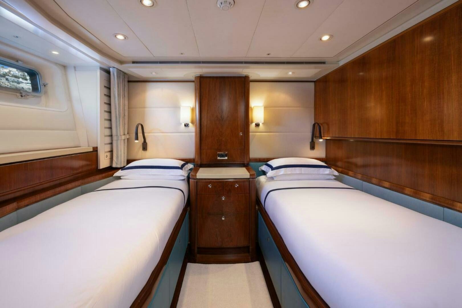 a room with a couple of beds aboard ANTARES Yacht for Sale
