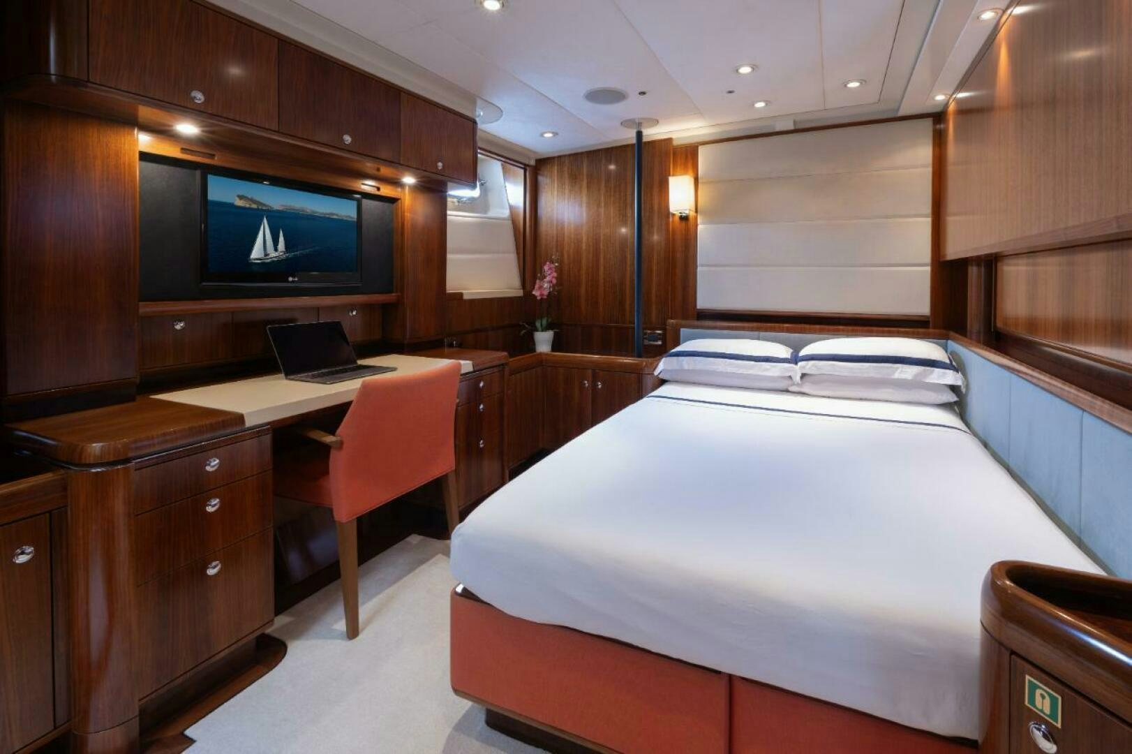 a room with a bed and desk aboard ANTARES Yacht for Sale