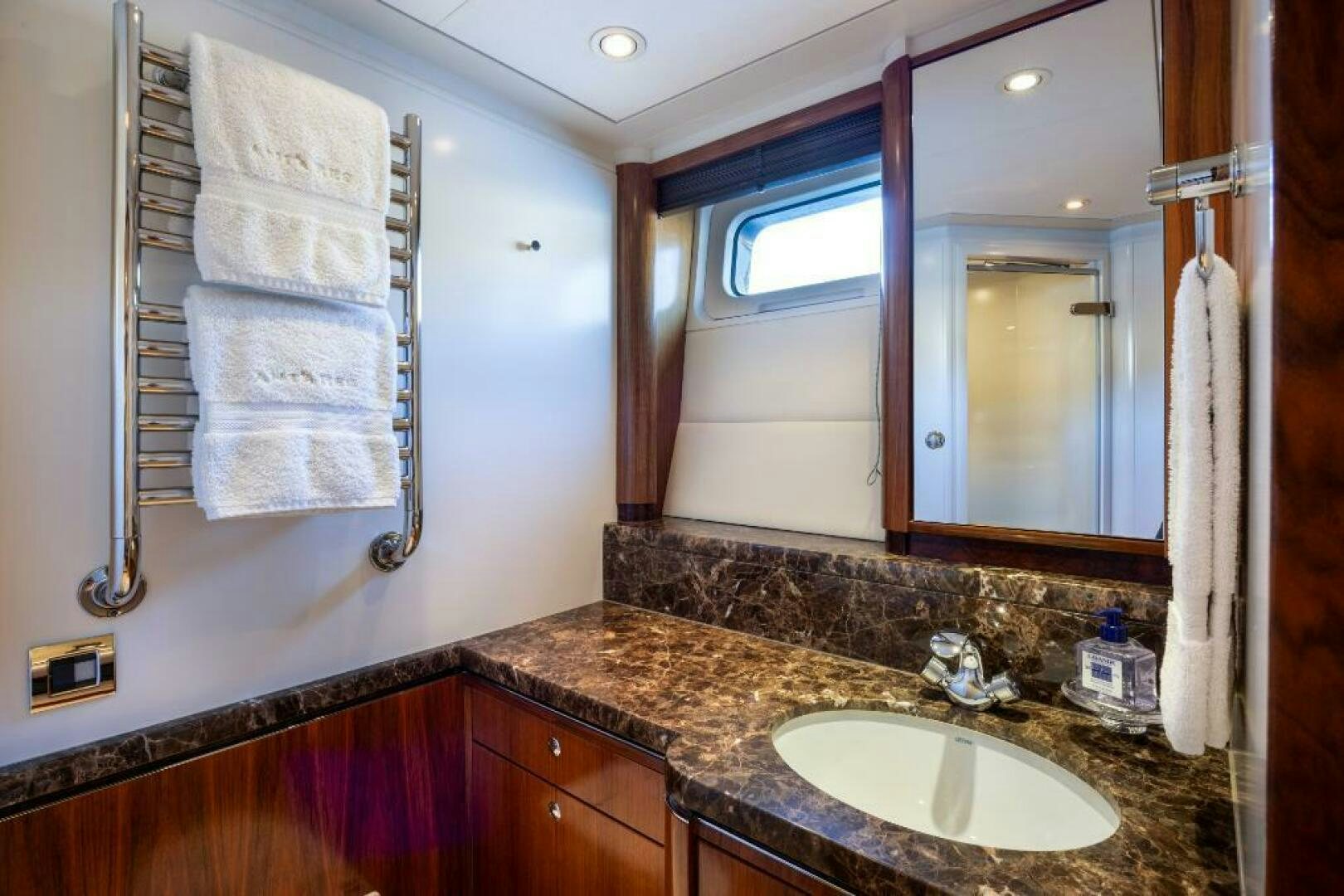a bathroom with a countertop sink and mirror aboard ANTARES Yacht for Sale