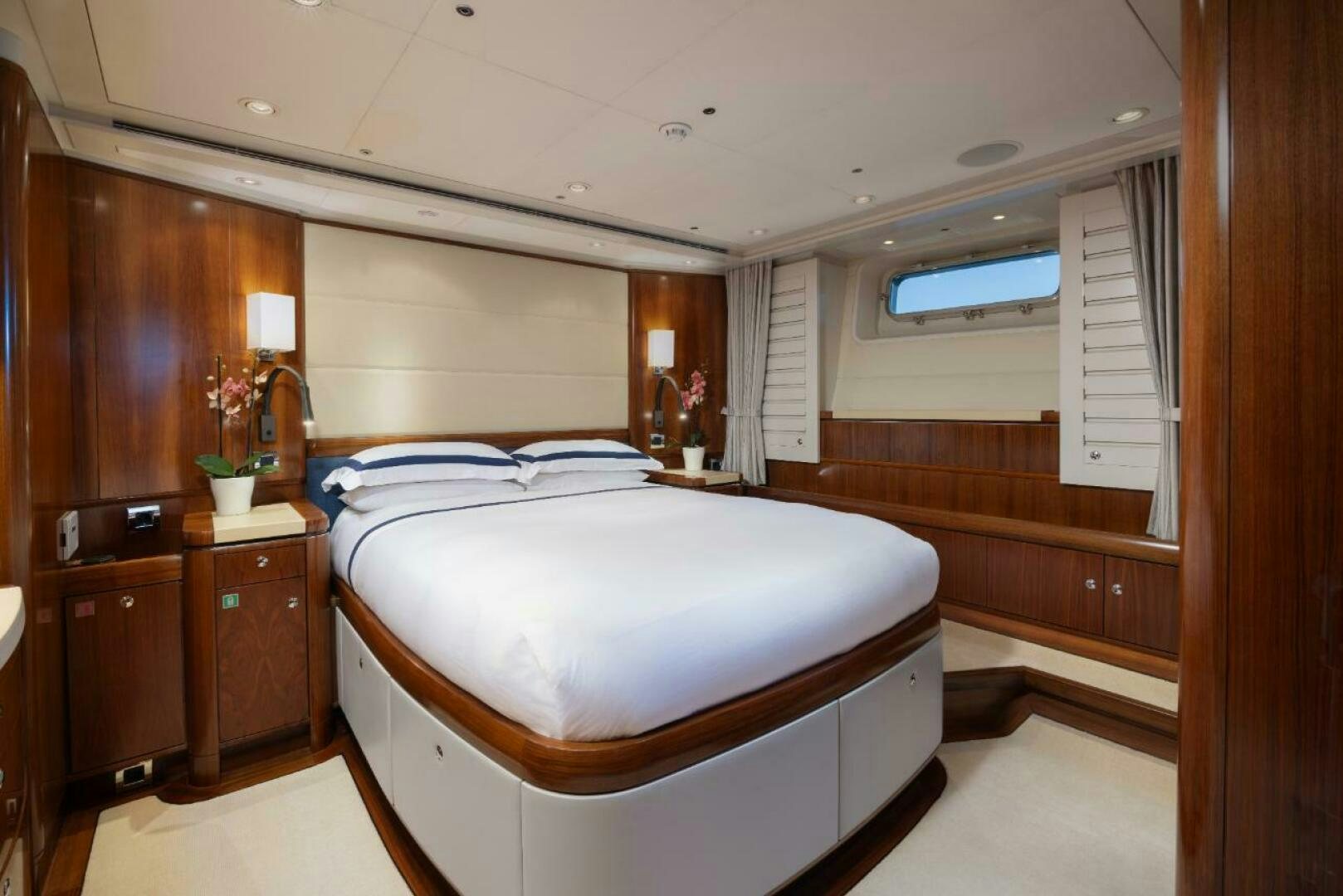 a bedroom with a bed and cabinets aboard ANTARES Yacht for Sale