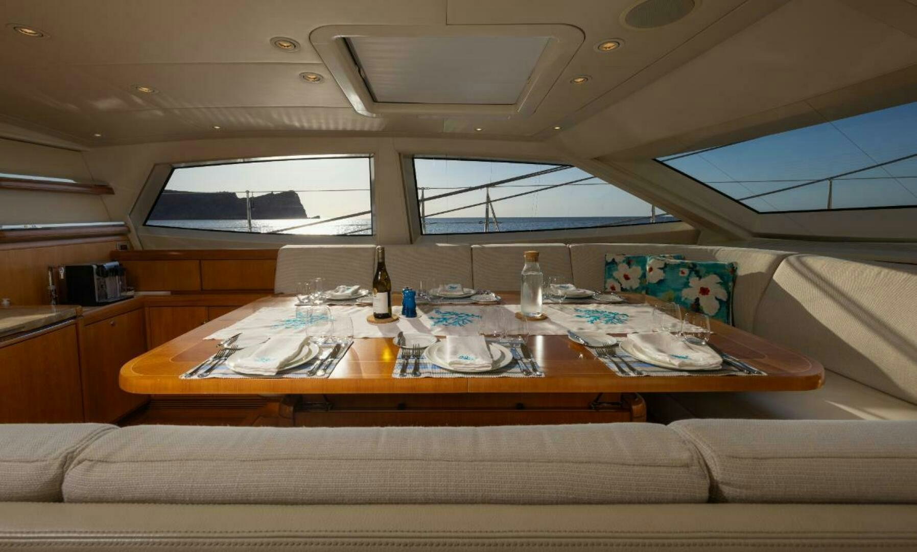a room with a couch and a table with food on it aboard ANTARES Yacht for Sale