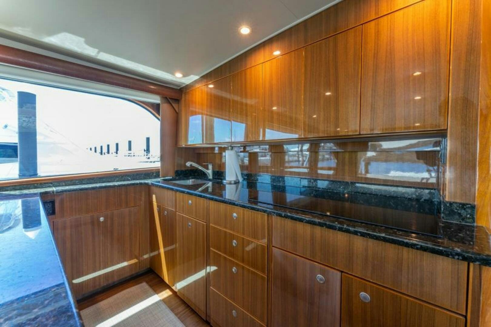 a kitchen with wooden cabinets aboard SALT STRUK Yacht for Sale
