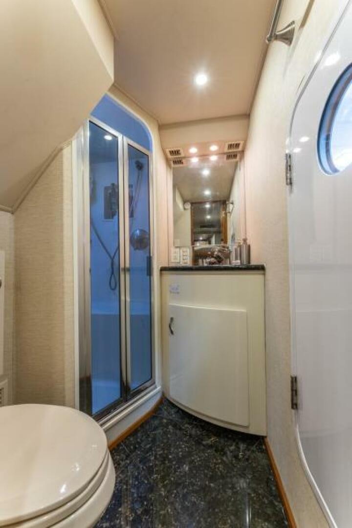 a bathroom with a blue door aboard SALT STRUK Yacht for Sale