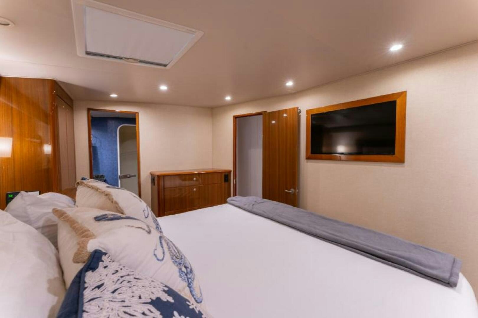 a hotel room with a bed and a television aboard SALT STRUK Yacht for Sale