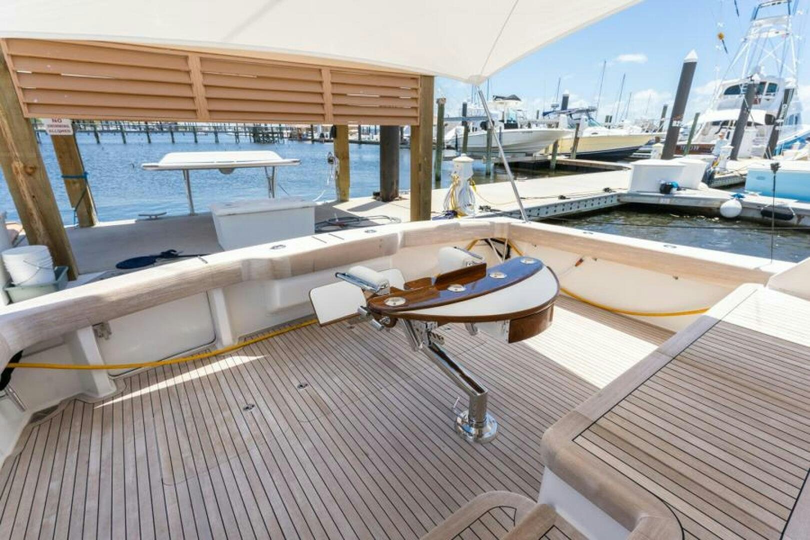 a deck with a table and chairs aboard SALT STRUK Yacht for Sale