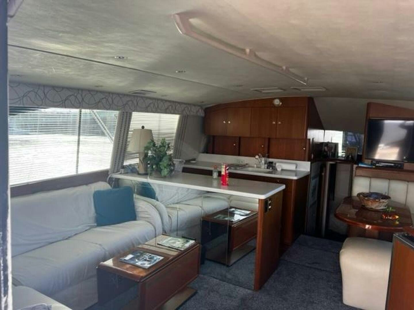 a living room with a couch and a television aboard GREAT WHITE Yacht for Sale