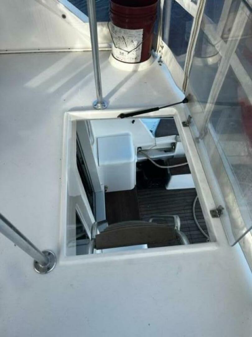 a white box with a lid and a chair on a white surface aboard GREAT WHITE Yacht for Sale