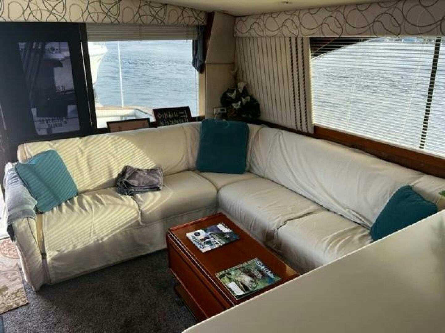 a living room with a couch and a tv aboard GREAT WHITE Yacht for Sale
