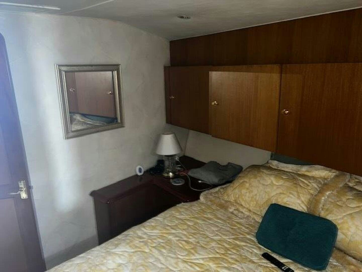 a bedroom with a bed and a mirror aboard GREAT WHITE Yacht for Sale