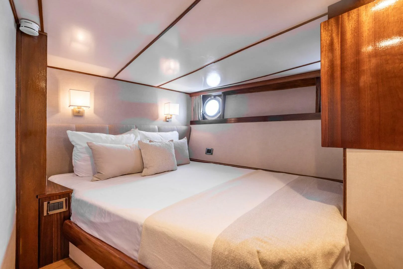 a room with a bed and a mirror aboard SISSI Yacht for Sale