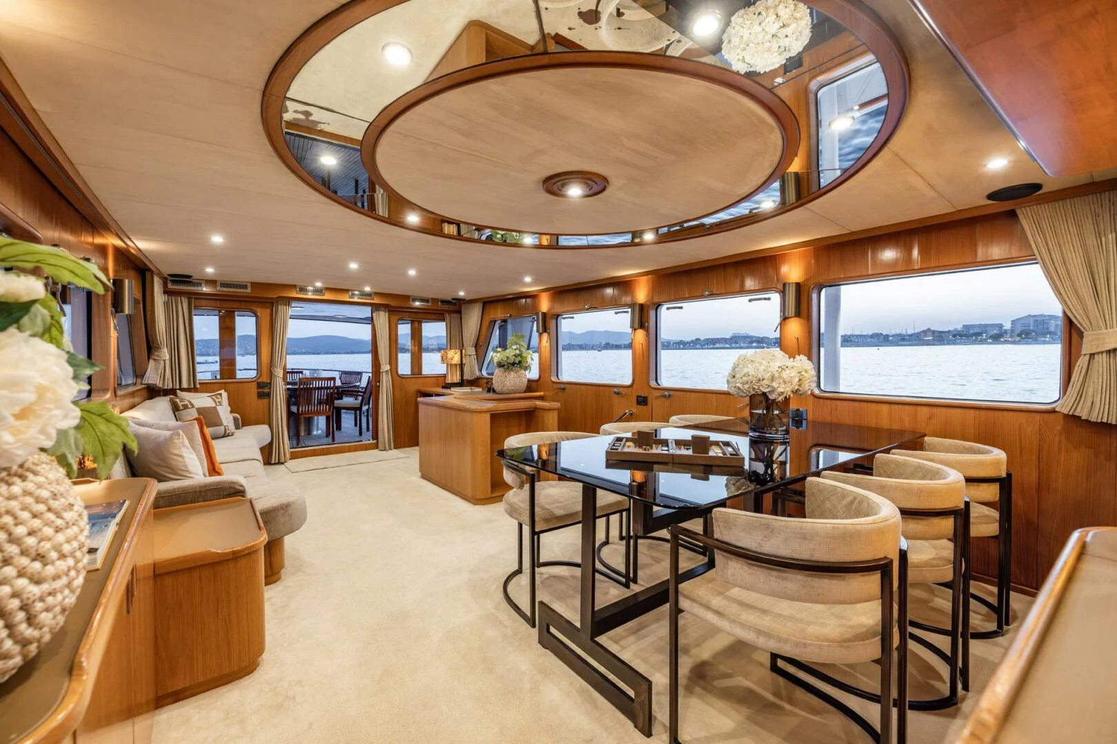 a large room with a table and chairs aboard SISSI Yacht for Sale